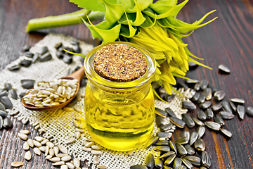 Image showing Oil sunflower in jar with flower on board