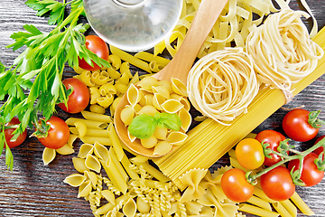 Image showing Pasta different with oil and tomatoes on board top