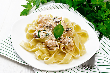 Image showing Pasta with salmon in cream on light board