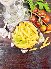 Image showing Penne in bowl of coconut with vegetables on board top