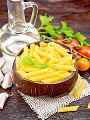 Image showing Penne in bowl of coconut with vegetables on dark board