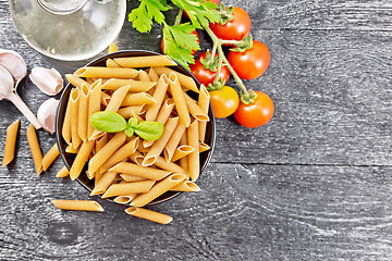 Image showing Penne whole grain in bowl with vegetables on board top