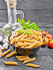 Image showing Penne whole grain in bowl with vegetables on dark board