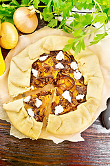 Image showing Pie with pumpkin and onions on board top