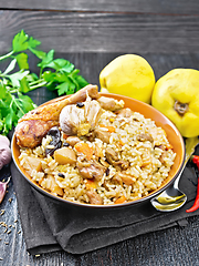 Image showing Pilaf with duck and quince in plate on napkin