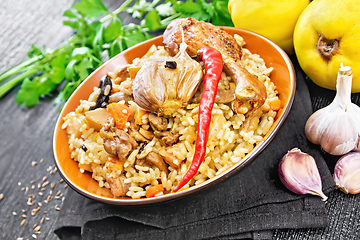 Image showing Pilaf with duck and quince in plate on table