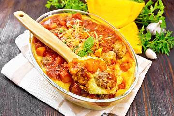 Image showing Porridge corn with meat and spoon in roaster on napkin