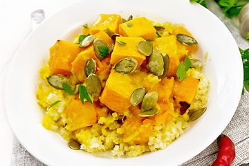 Image showing Porridge millet with spicy pumpkin in plate on board