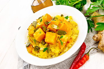 Image showing Porridge millet with spicy pumpkin in plate on table