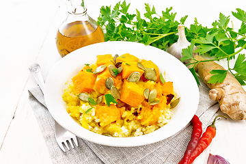 Image showing Porridge millet with spicy pumpkin in plate on towel