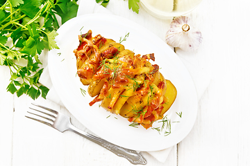 Image showing Potatoes puff bacon in plate on board top