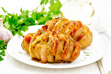 Image showing Potatoes puff smoked bacon in plate on board