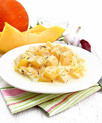 Image showing Pumpkin with sour cream sauce in plate on table