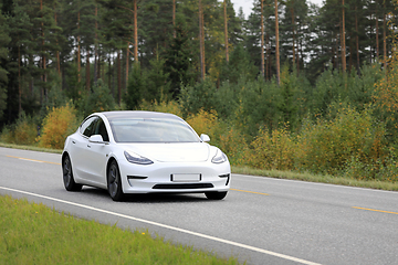 Image showing White Tesla Model 3 Electric Car on Rural Highway
