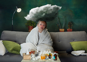 Image showing Ill young girl with fever and cold looks suffering at home