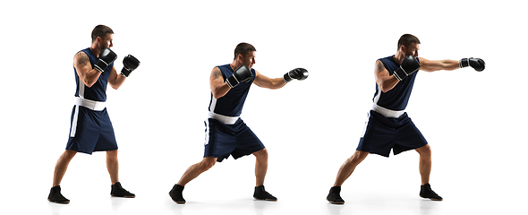 Image showing Young boxer against white studio background in motion of step-to-step kicking