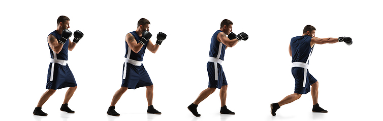 Image showing Young boxer against white studio background in motion of step-to-step kicking