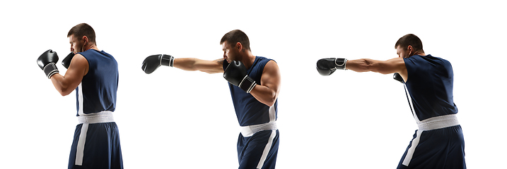 Image showing Young boxer against white studio background in motion of step-to-step kicking