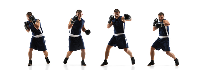 Image showing Young boxer against white studio background in motion of step-to-step kicking