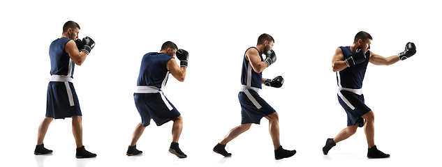 Image showing Young boxer against white studio background in motion of step-to-step kicking