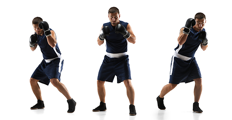 Image showing Young boxer against white studio background in motion of step-to-step kicking