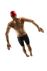 Image showing Caucasian professional sportsman, swimmer training isolated on white studio background