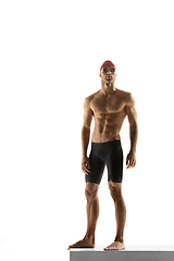 Image showing Caucasian professional sportsman, swimmer training isolated on white studio background