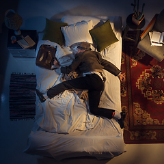 Image showing Portrait of a businessman, accountant sleeping in the bed at home