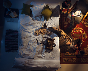 Image showing Portrait of a businessman, accountant sleeping in the bed at home