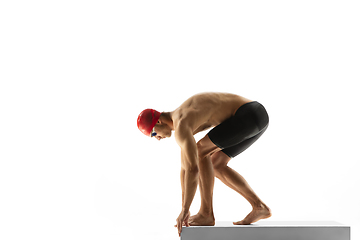 Image showing Caucasian professional sportsman, swimmer training isolated on white studio background