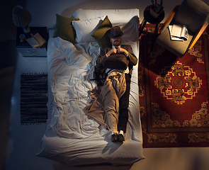 Image showing Portrait of a businessman, accountant sleeping in the bed at home