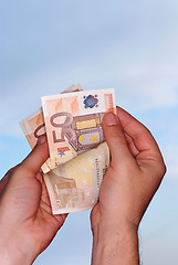 Image showing Counting money,clipping path included