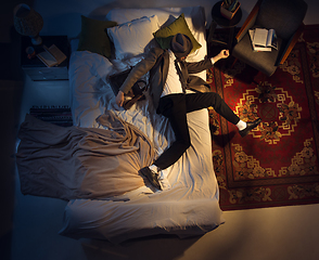 Image showing Portrait of a businessman, accountant sleeping in the bed at home