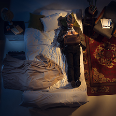 Image showing Portrait of a businessman, accountant sleeping in the bed at home