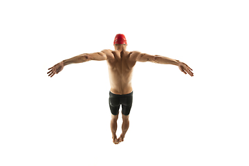 Image showing Caucasian professional sportsman, swimmer training isolated on white studio background