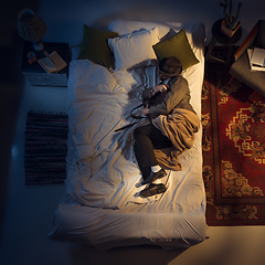 Image showing Portrait of a businessman, accountant sleeping in the bed at home