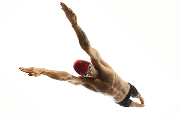 Image showing Caucasian professional sportsman, swimmer training isolated on white studio background