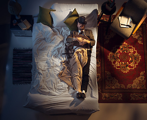 Image showing Portrait of a businessman, accountant sleeping in the bed at home