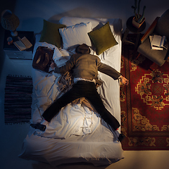 Image showing Portrait of a businessman, accountant sleeping in the bed at home