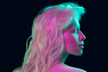 Image showing Portrait of beautiful albino girl isolated on dark studio background in neon light