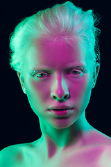 Image showing Portrait of beautiful albino girl isolated on dark studio background in neon light