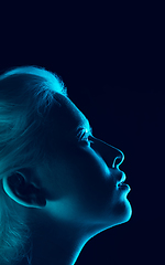 Image showing Portrait of beautiful albino girl isolated on dark studio background in neon light