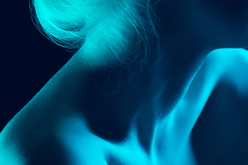 Image showing Portrait of beautiful albino girl isolated on dark studio background in neon light