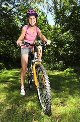 Image showing Teenage girl on a bicycle