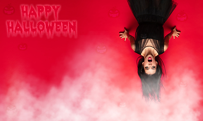 Image showing Young woman a witch on scary background