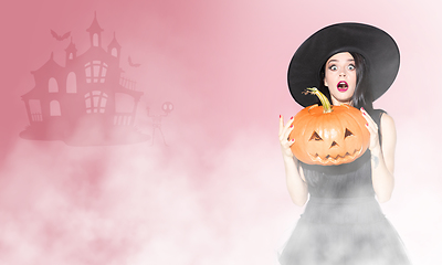 Image showing Young woman a witch on scary background