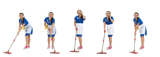 Image showing Portrait of female made, cleaning worker in white and blue uniform isolated over white background