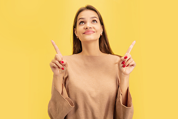 Image showing Portrait of young caucasian woman with bright emotions isolated on yellow studio background