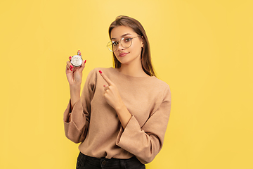 Image showing Portrait of young caucasian woman with bright emotions isolated on yellow studio background