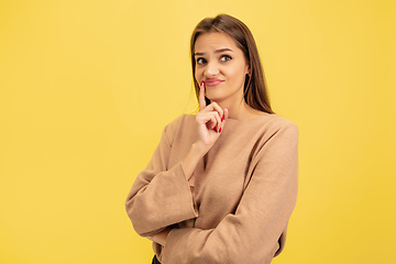 Image showing Portrait of young caucasian woman with bright emotions isolated on yellow studio background